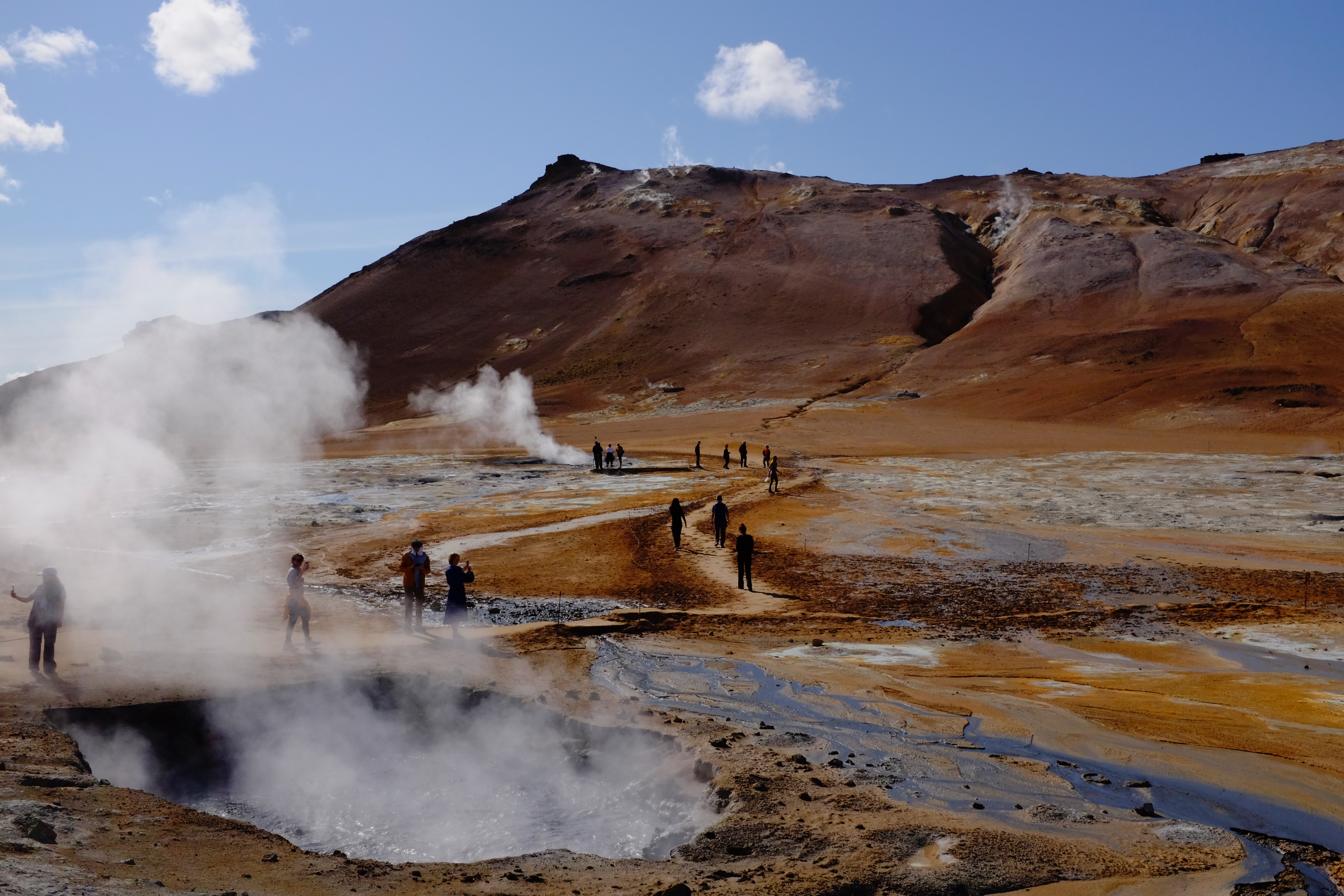 A geothermal area in Iceland with steam rising from the ground