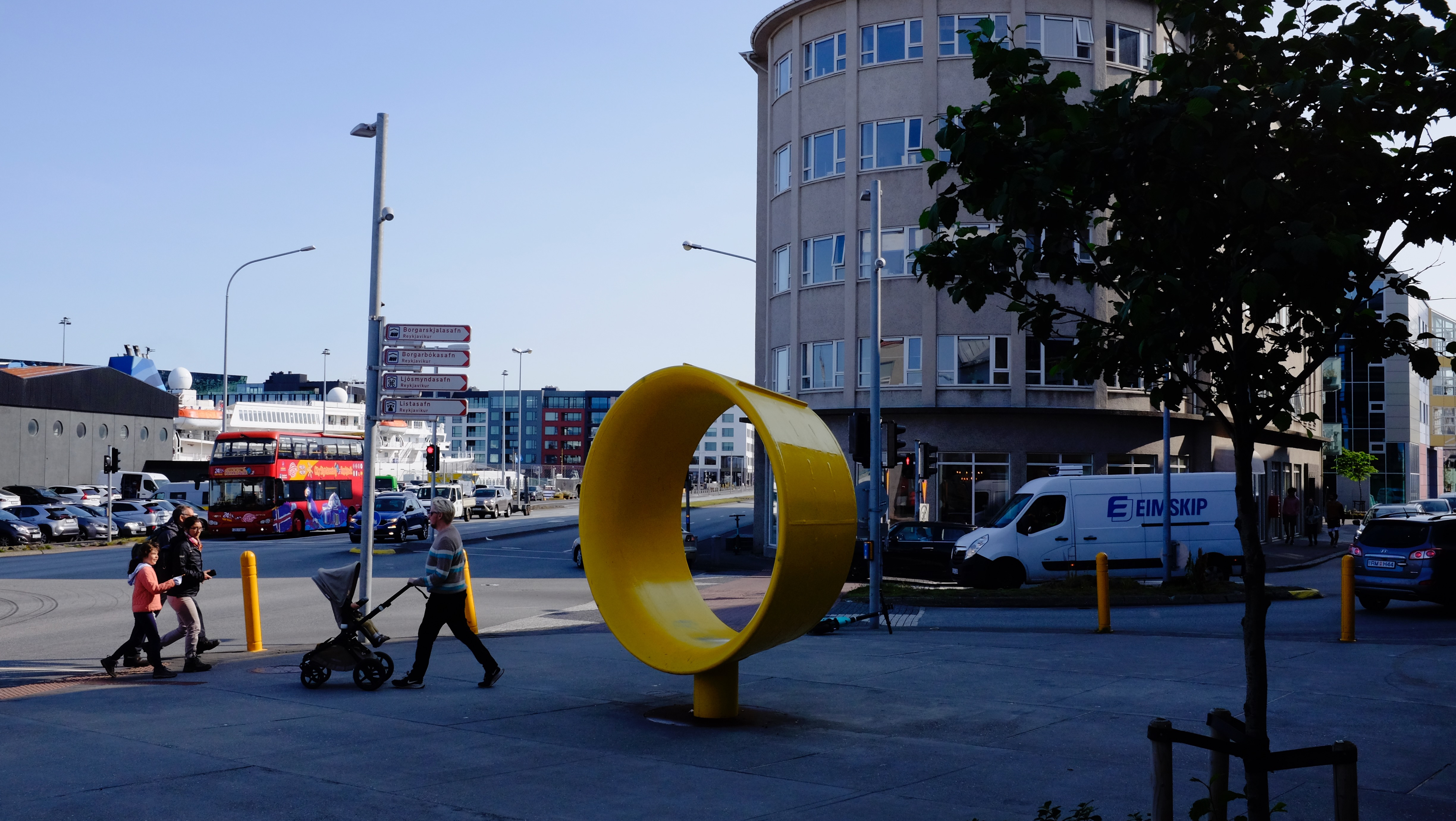 Street in Reykjavik with a large yellow ring sculpture